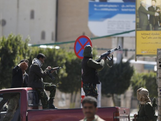 A Houthi fighter fires at forces guarding the Presidential Palace during clashes in Sanaa